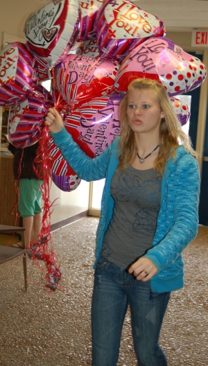 Holly Dempsey delivers Valentine balloons to the junior high. Balloon sales are a traditional fundraiser for the junior class.