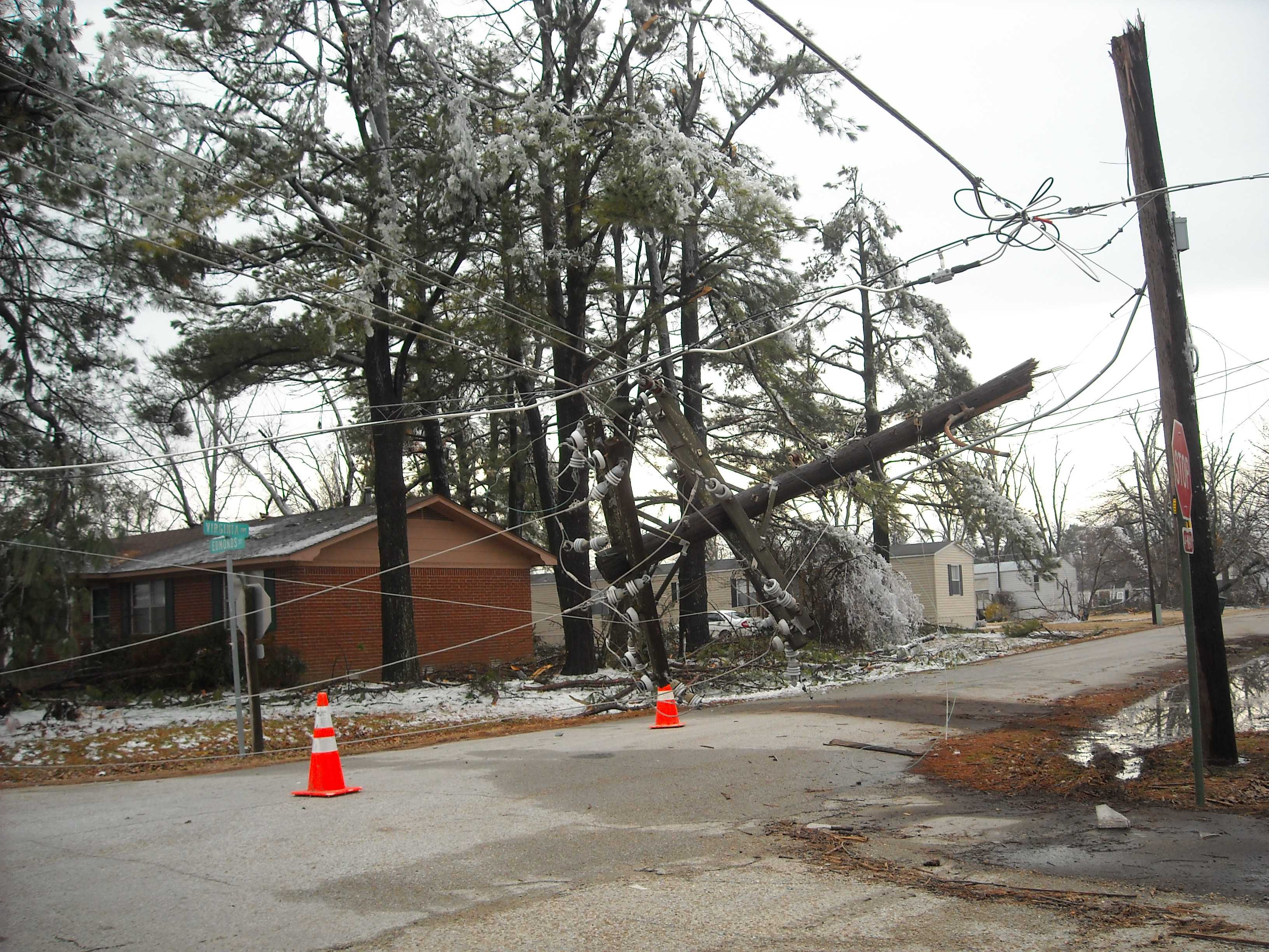 Downed power lines hang precariously over a Monette intersection