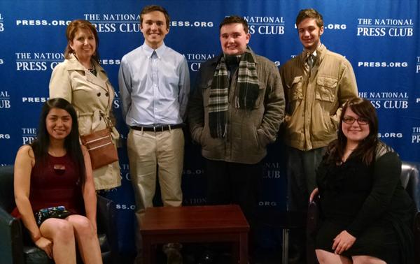 Joanna Perez, Tracey Yates, Drew McFall, Greydon Williams, Camden Metheny and Olevia Hughes at the National Press Club. After dining at the club's Fourth Estate Restaurant, they were allowed to explore the area, including the press conference room. 