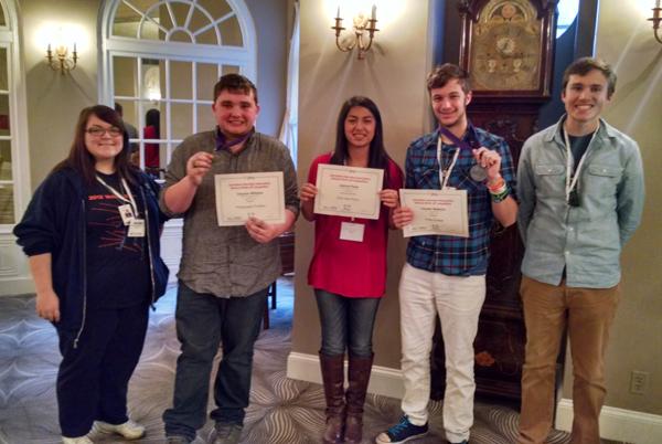 Journalism staff members display their awards after the closing ceremony at the JEA Convention.