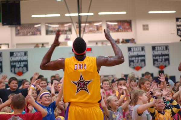 Wizard Big J gets the crowd going at the end of the game.