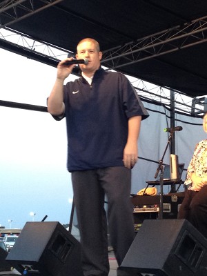 Coach Justin Yates on stage at the NEA District Fair.