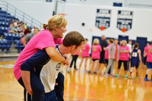 Kindergarten teacher and basketball mom April Finch gets assistance from sophomore Andrew McFarlin during the Hoops N Heels event Tuesday night at the MAC. 