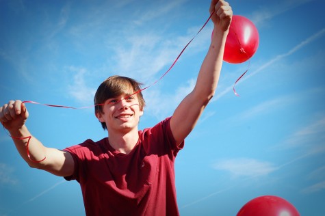 Senior Jacob Cater is lifted up during the balloon release at Thursdays Red Ribbon assembly. The program was conducted by the EAST students and featured a video and two area residents who spoke about overcoming addiction. Following the presentation, students and staff gathered in front of the MAC for a balloon release.