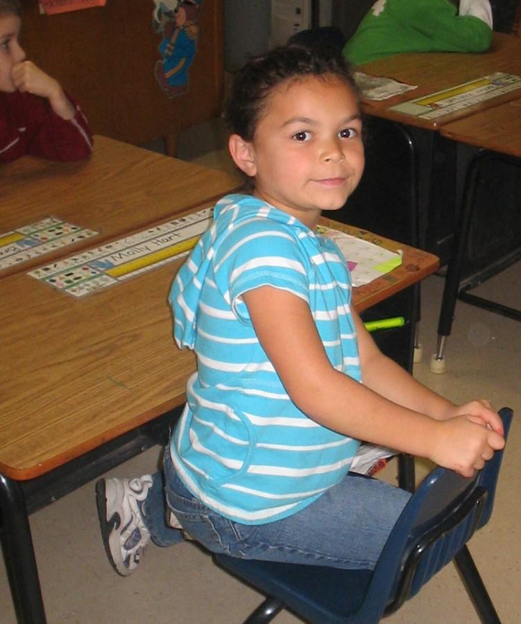 Sophomore Molly Hart sits at her elementary school desk in this 2006 photo. 