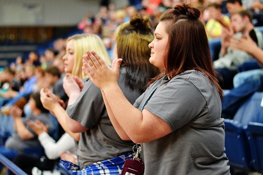 Sarah Vaughn, 12, applauds the speakers during the assembly.