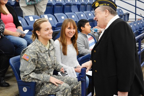 Seniors Natalie Campbell and Jessica Krob talk with Navy veteran Marie George before Mondays assembly. 