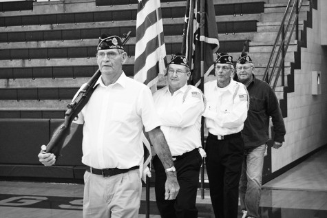 Larry Rolland (front) of Monette leads the color guard at the start of Mondays Veterans Day assembly in the MAC.
