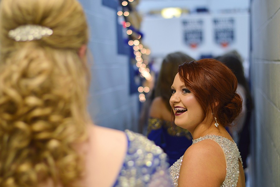 Junior princesses Lexie Ray (right) and Avery Uthoff joke around while waiting for the homecoming ceremony to start. 