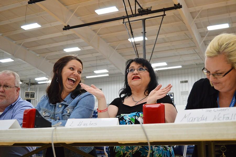 Principal Randy Rose, Stephanie Woods, Lisa Hughes and Mandy McFall react during the student-teacher Quiz Bowl game on Wednesday. The teachers played the Quiz Bowl team in preparation for the state tournament on April 9. The teacher team won with a score of 240-210.