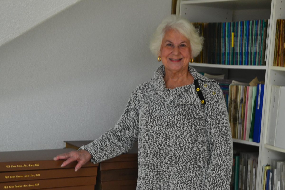 Local historian Nan Snider poses in front of her collection of Town Crier newspapers.